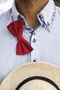 Man in shirt with untied bow-tie and wicker hat Royalty Free Stock Photo