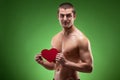 Man shirtless holding heart shape