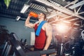 Man with a towel and shaker beside a treadmill Royalty Free Stock Photo