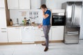 Man Shocked On Seeing Foam Coming Out Of Dishwasher Royalty Free Stock Photo