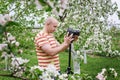 Man shoot at the camera in a blossoming spring garden Royalty Free Stock Photo