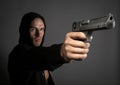 Man shooting gun isolated on gray background Royalty Free Stock Photo