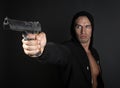 Man shooting gun isolated on gray background Royalty Free Stock Photo