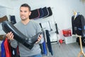 Man in shop holding riding boot Royalty Free Stock Photo