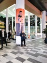 A man in a shopping center uses a smartphone