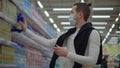 Man on shopping in food store during seasonal epidemic of respiratory diseases