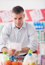 Man shopping with a grocery list Royalty Free Stock Photo