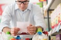 Man shopping with a grocery list Royalty Free Stock Photo