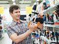 Man shopping for perforator in hardware store