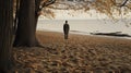 A man on the shore of a lake or the sea looks longingly into the distance