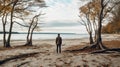 A man on the shore of a lake or the sea looks longingly into the distance