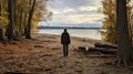 A man on the shore of a lake or the sea looks longingly into the distance