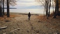 A man on the shore of a lake or the sea looks longingly into the distance