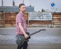 Man in short sleeve shirt holding electric guitar Royalty Free Stock Photo