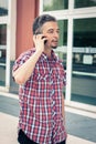 Man in short sleeve shirt talking on phone Royalty Free Stock Photo