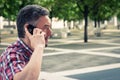 Man in short sleeve shirt talking on phone Royalty Free Stock Photo