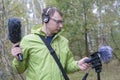 The man with Shotgun Condenser Microphone and headphones is recording the sounds of nature. Royalty Free Stock Photo