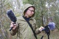 The man with Shotgun Condenser Microphone and headphones is recording the sounds of nature. Royalty Free Stock Photo