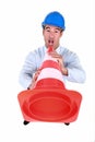 Man shouting into traffic cone Royalty Free Stock Photo