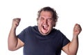 Man shouts, lifting his hands up into fists. Excited man celebrating success with hands raised against white background