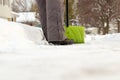 Man shoveling and removing snow in front of his house in the suburb. Royalty Free Stock Photo