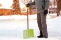 Man shoveling and removing snow in front of his house in the suburb. Royalty Free Stock Photo