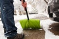 Man shoveling and removing snow in front of his house in the suburb Royalty Free Stock Photo