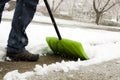 Man shoveling and removing snow in front of his house in the suburb Royalty Free Stock Photo