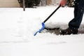 Man shoveling and removing snow in front of his house in the suburb Royalty Free Stock Photo