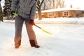 Man shoveling and removing snow in front of his house in the suburb. Royalty Free Stock Photo