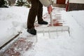 Man shoveling snow at a footpath