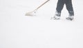 Man shoveling snow at a footpath Royalty Free Stock Photo