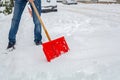 Man shoveling snow on road