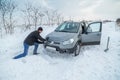 Man shoveling snow to free his stuck car Royalty Free Stock Photo