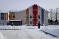 Man is shovelling snow in front of the building of Lesovichok nursery school in Ordzhonikidze street of Balashikha, Russia.