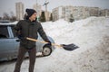 Man Is Shovelling Snow Near The Car. Winter Shoveling. Royalty Free Stock Photo