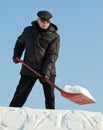 Man shovelling snow with a red shovel Royalty Free Stock Photo