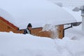 A man shovels snow from a sidewalk in the winter Royalty Free Stock Photo