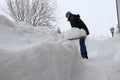 A man shovels snow from a sidewalk in the winter Royalty Free Stock Photo