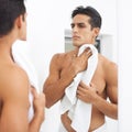 Man, shower and towel after washing in mirror, cleaning and skincare or beauty and cosmetic. Male person, bathroom and Royalty Free Stock Photo