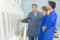 Man showing aircraft fuselage to students Royalty Free Stock Photo