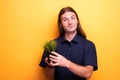 Man showing apartment plant in a pot