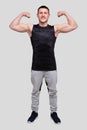 Man Showing Biceps Hands Up. Sportsman Showing Muscles. ABS, Biceps Muscles. Man Standing Isolated