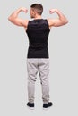 Man Showing Biceps Hands Up. Sportsman Showing Muscles. ABS, Biceps Muscles. Man Standing Isolated