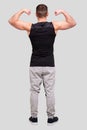 Man Showing Biceps Hands Up. Sportsman Showing Muscles. ABS, Biceps Muscles. Man Standing Isolated