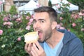 Man showing gluttony while eating dessert