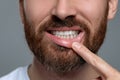 Man showing healthy gums on gray background, closeup Royalty Free Stock Photo