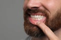 Man showing healthy gums on gray background, closeup. Space for text Royalty Free Stock Photo