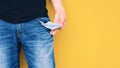 Man showing his empty pocket on yellow wall background Royalty Free Stock Photo