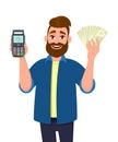 Man showing / holding credit / debit card POS terminal payment swipe machine and holding cash, money, currency or in hand.